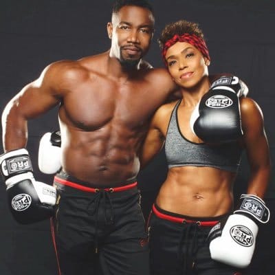 1W-J23Dw_400x400 "Michael Jai White, martial arts master with 8 black belts, executing a karate technique while wearing his traditional gi"
